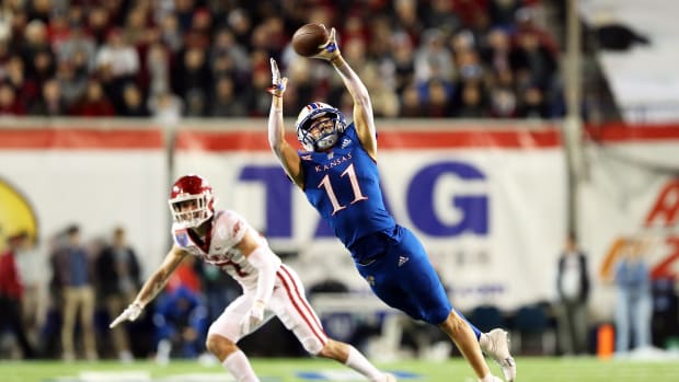 Dec 28, 2022; Memphis, TN, USA; Kansas Jayhawks slot receiver Luke Grimm (11) reaches for a pass in the third quarter against the Arkansas Razorbacks in the 2022 Liberty Bowl at Liberty Bowl Memorial Stadium.